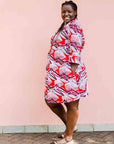 Model wearing a red, grey and maroon geometric shirt dress