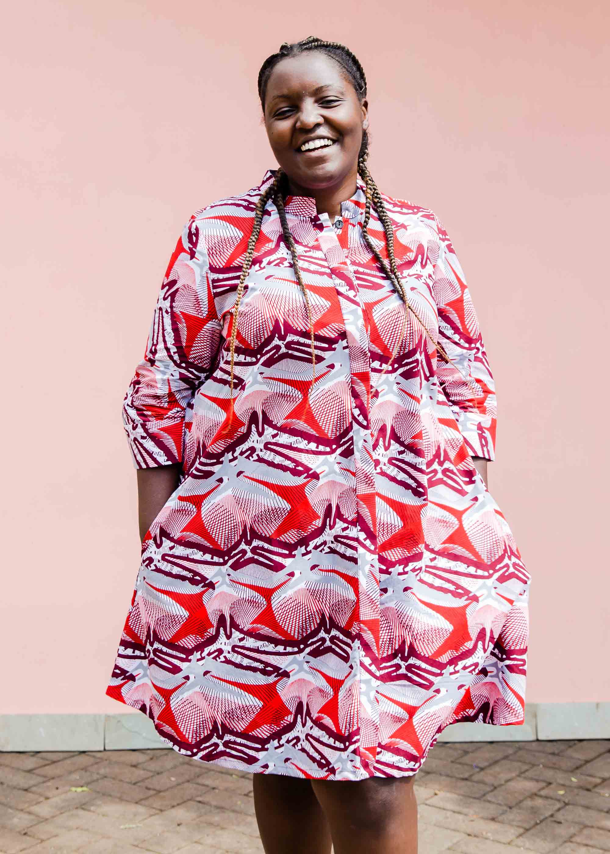 Model wearing a red, grey and maroon geometric shirt dress