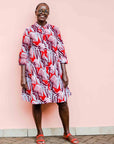 Model wearing a red, grey and maroon geometric shirt dress