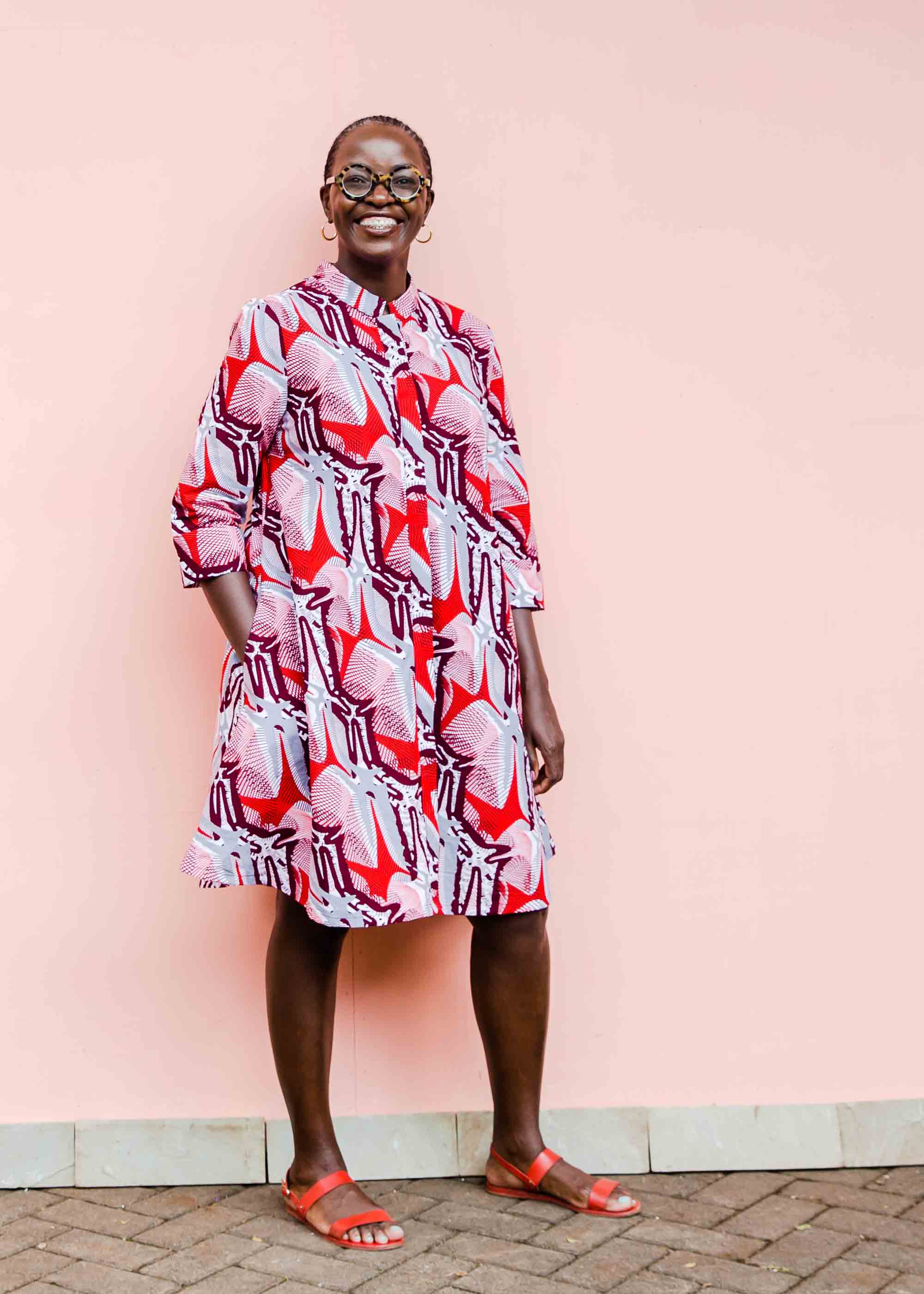 Model wearing a red, grey and maroon geometric shirt dress