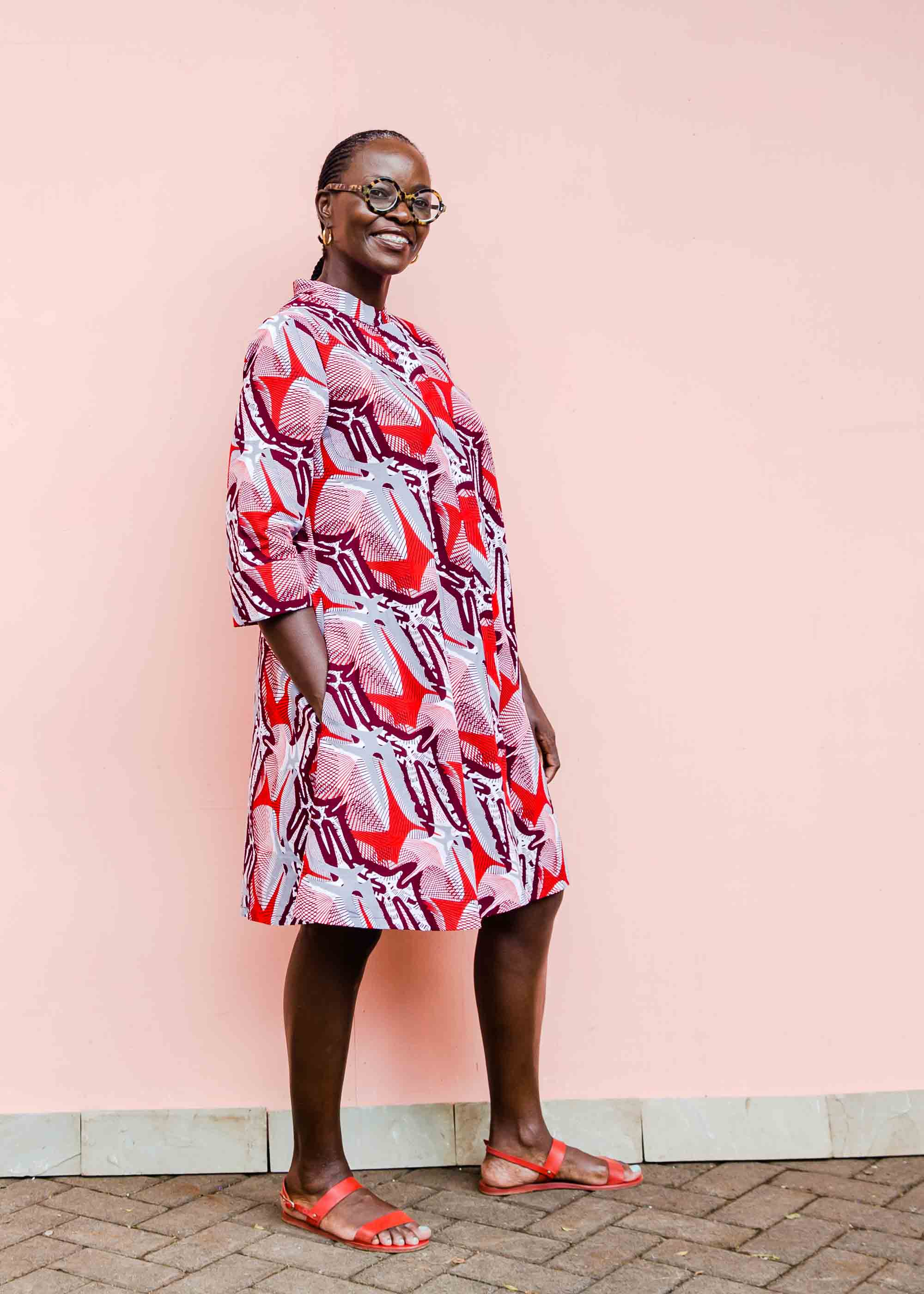 Model wearing a red, grey and maroon geometric shirt dress