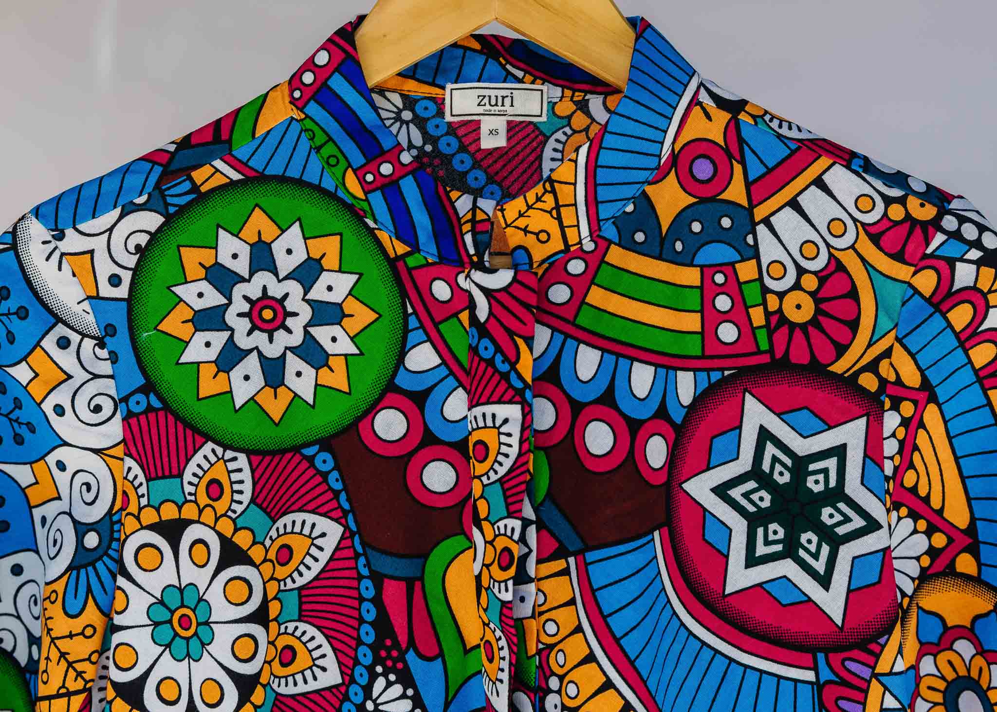 Display of rainbow mosaic print dress.