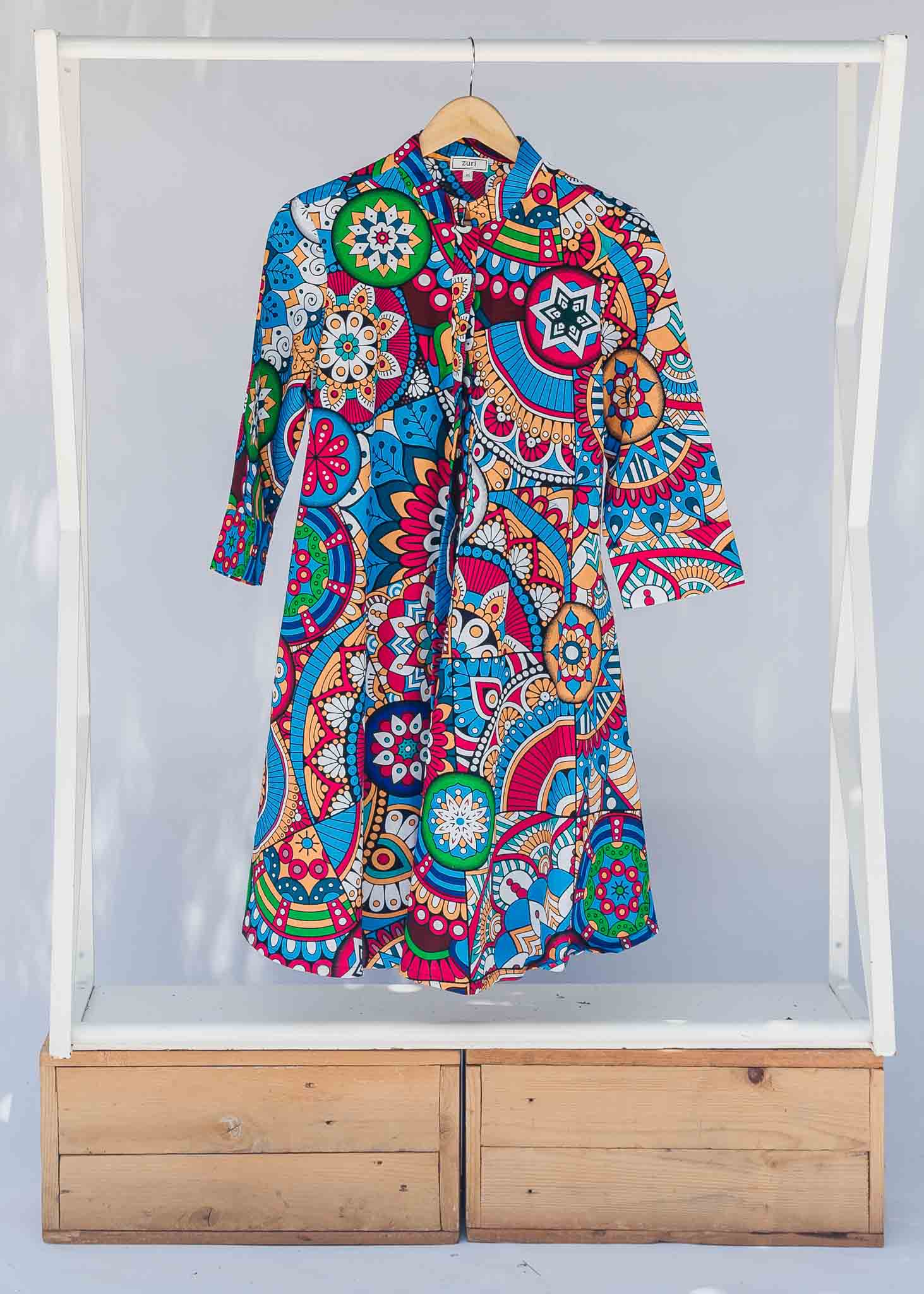 Display of rainbow mosaic print dress.