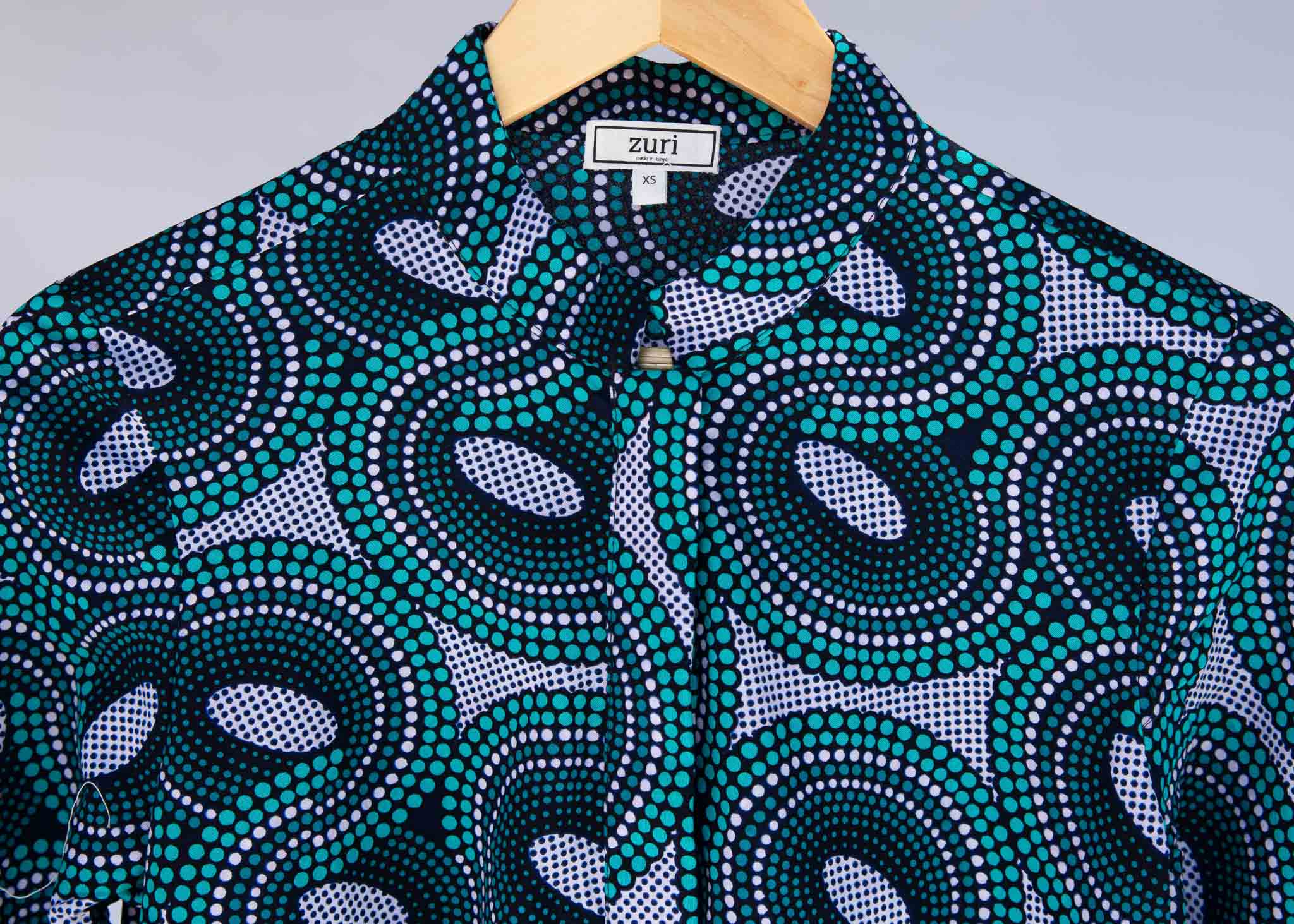 Display of dress with teal shaded loop print.
