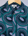 Display of dress with teal shaded loop print.