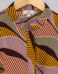 Display of neutral color geometric print dress.