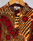 Display of brown dress with red snap pea print.