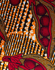 Display of brown dress with red snap pea print.