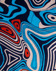 Close up display of beige, orange, navy and aqua, abstract print dress, fabric.