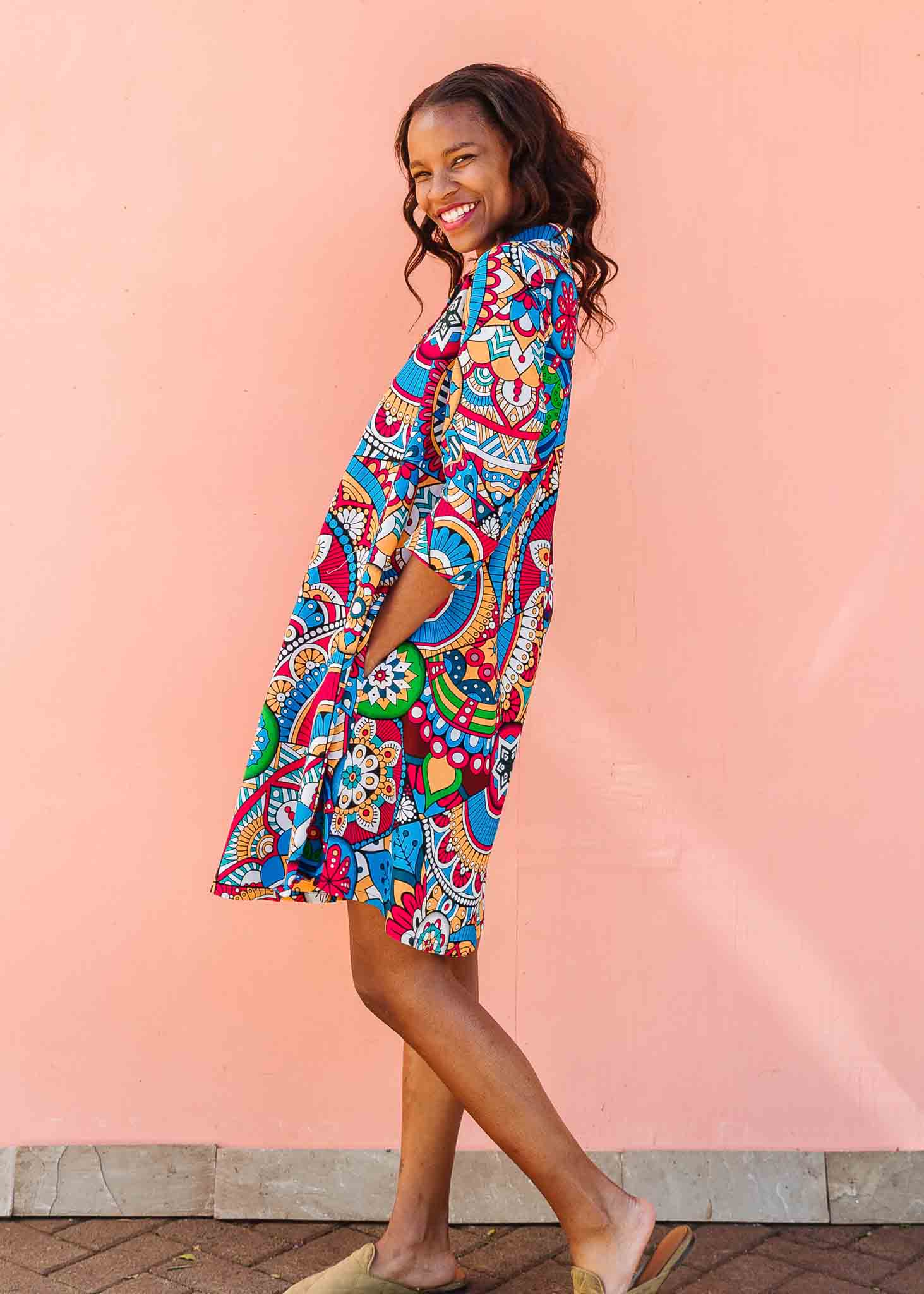 Model wearing rainbow mosaic print dress.