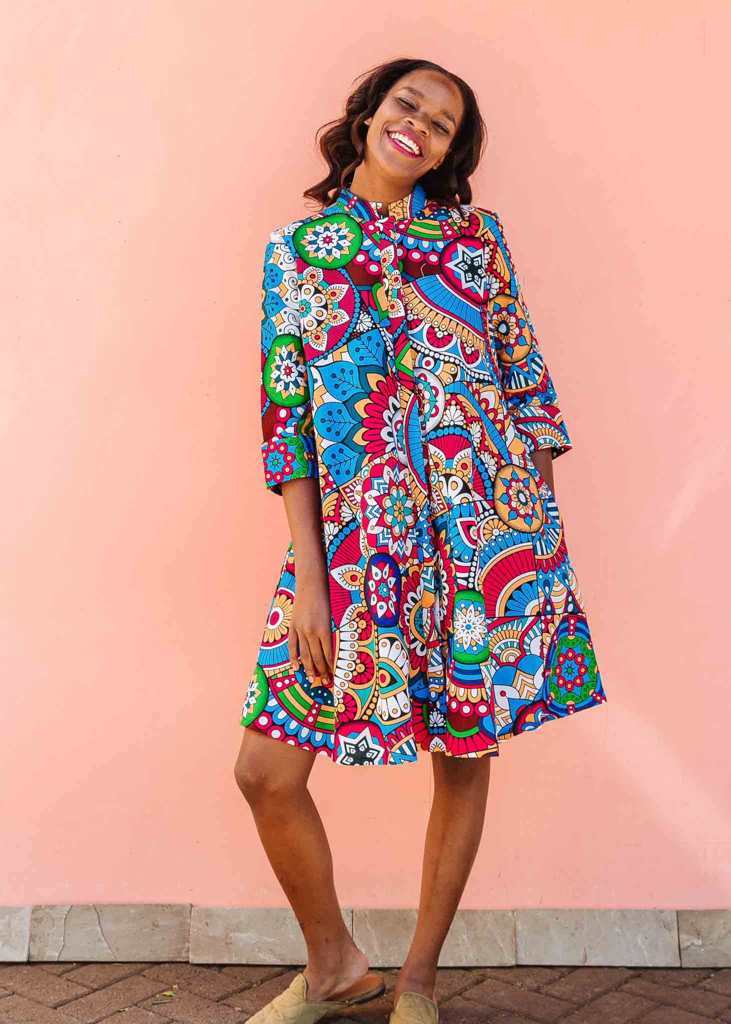 Model wearing rainbow mosaic print dress.