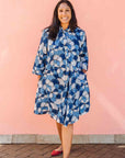 Model wearing blue and white floral print dress.