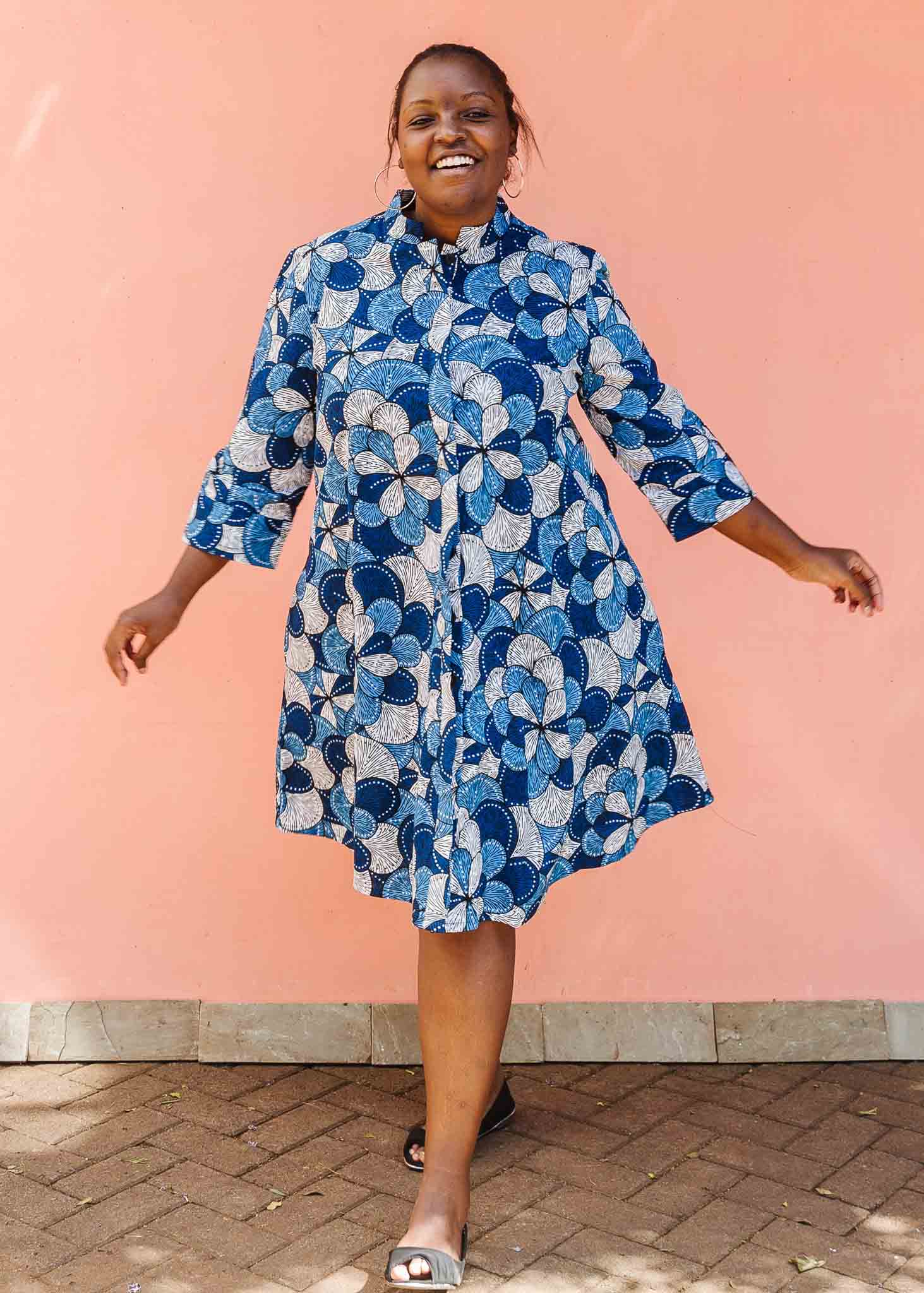 Model wearing blue and white floral print dress.