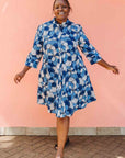 Model wearing blue and white floral print dress.