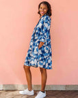 Model wearing blue and white floral print dress.