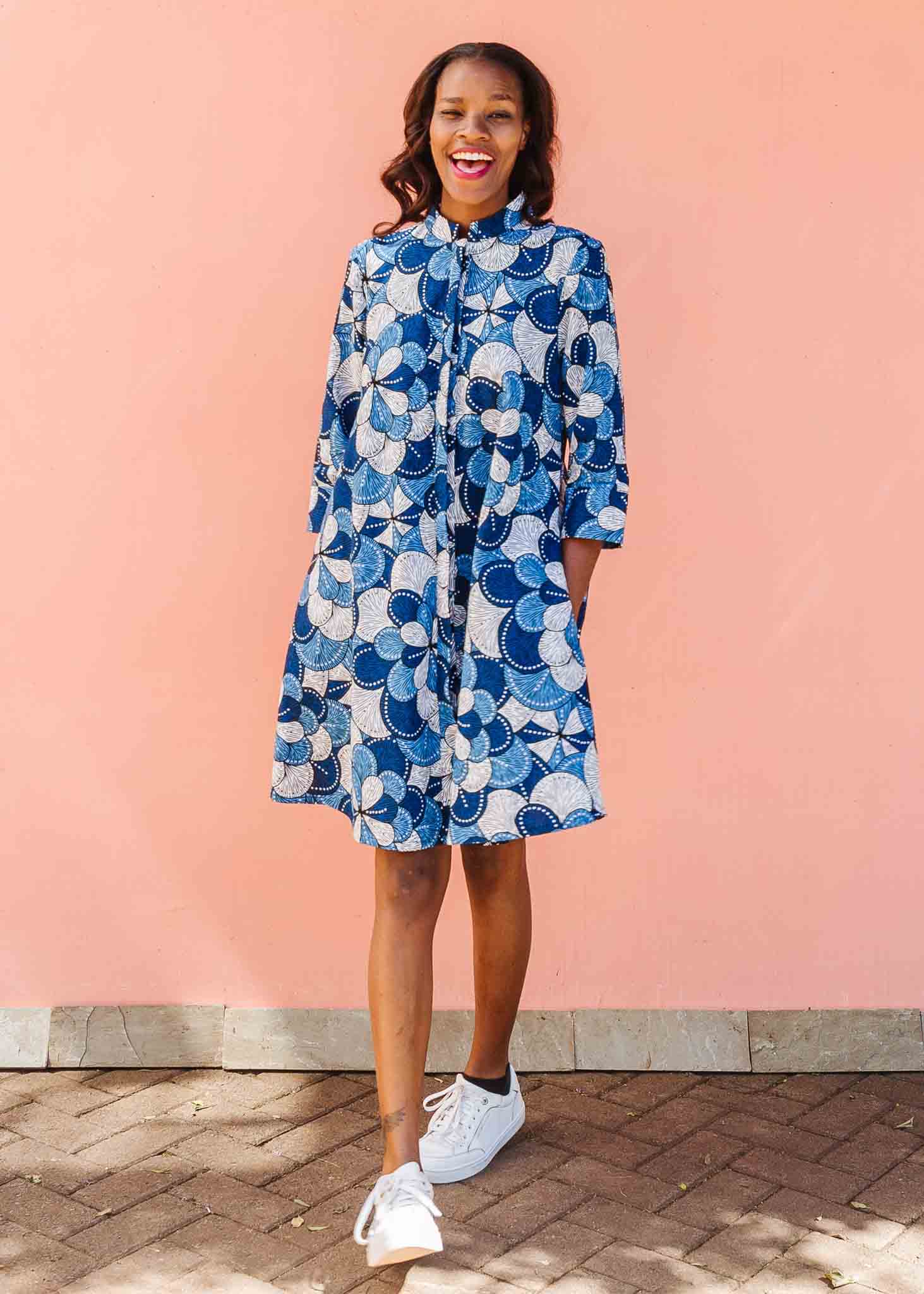 Model wearing blue and white floral print dress.