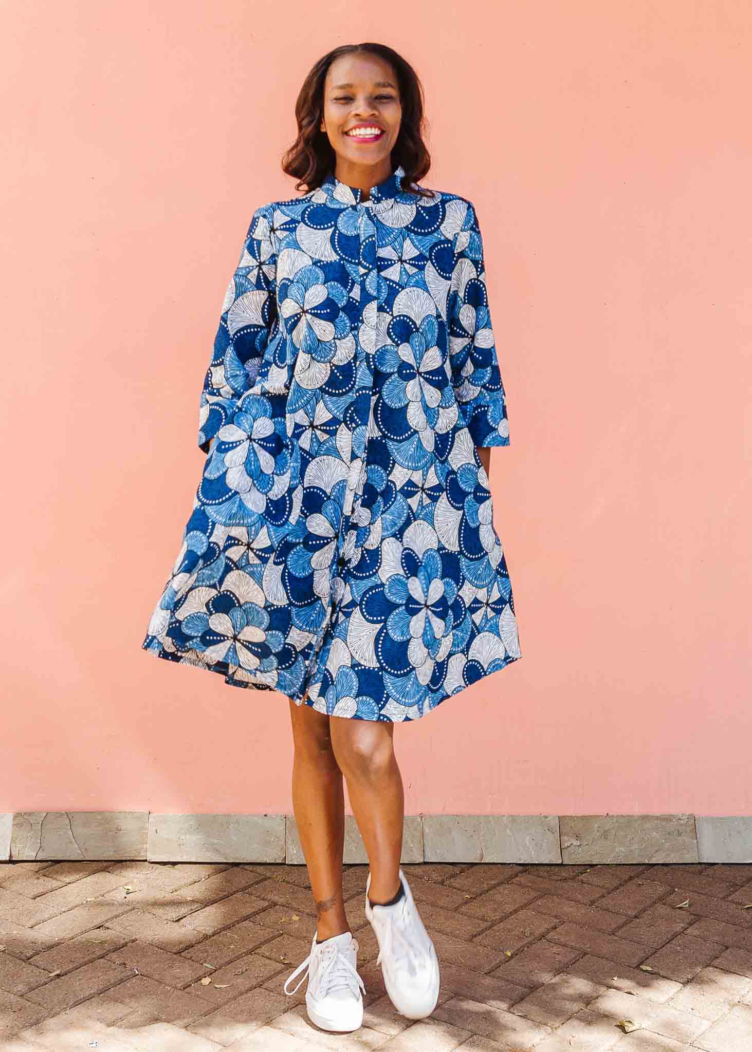 Model wearing blue and white floral print dress.