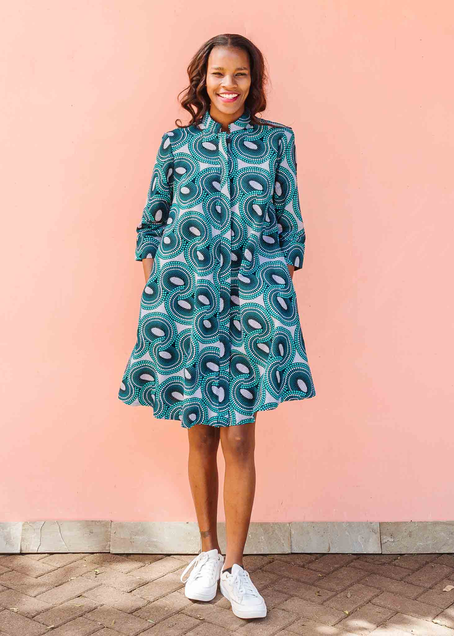 Model wearing dress with teal shaded loop print.