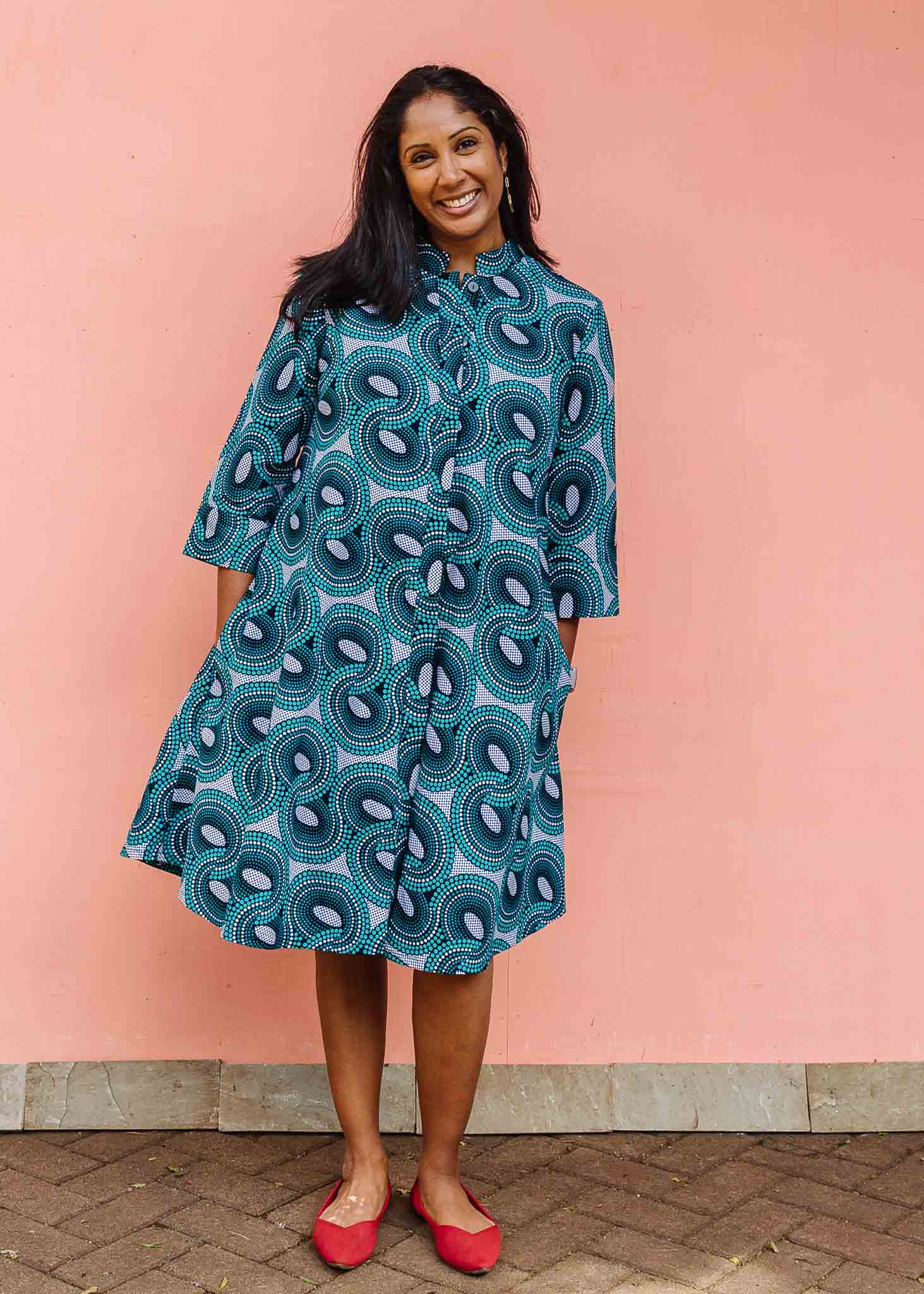 Model wearing dress with teal shaded loop print.