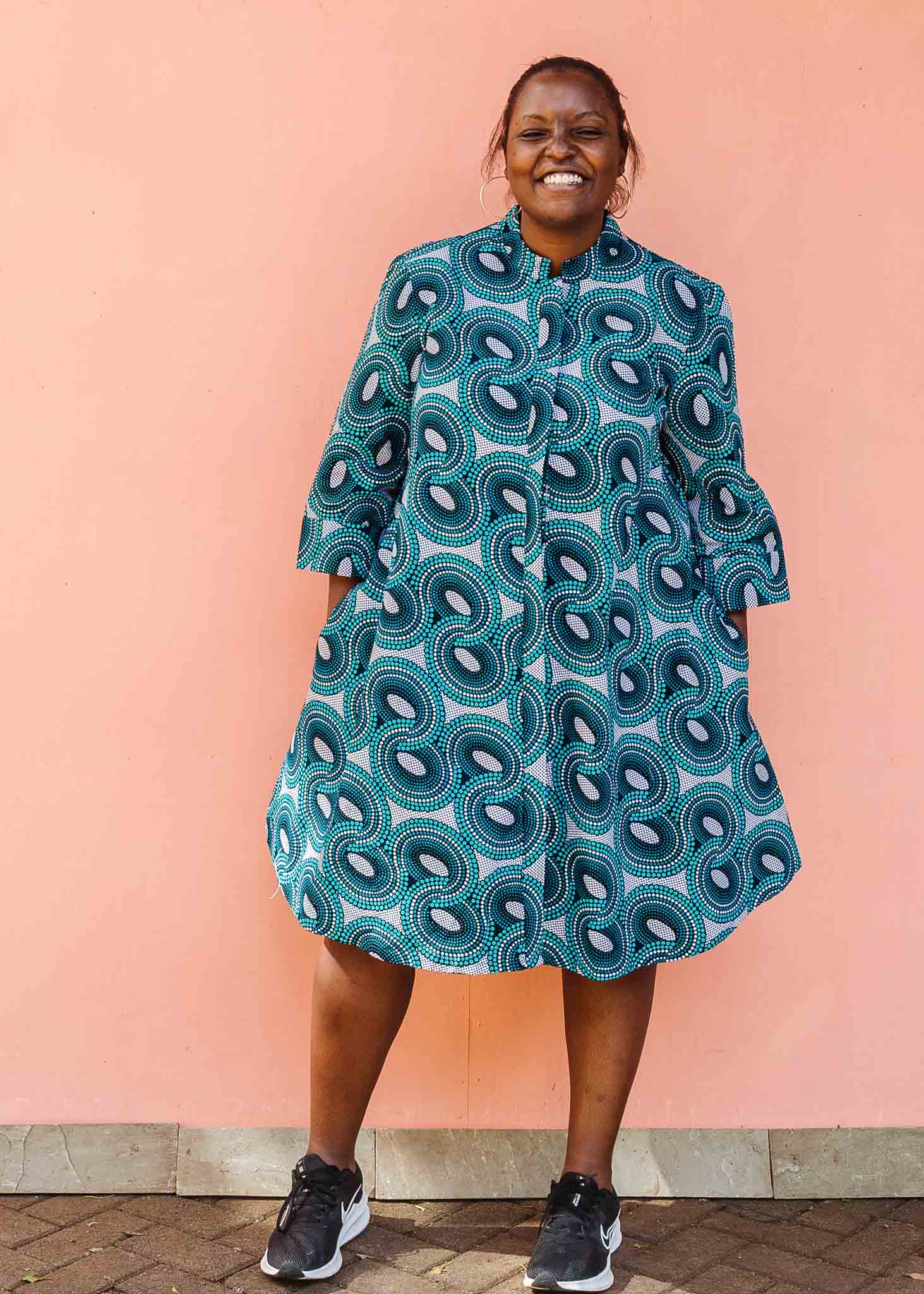 Model wearing dress with teal shaded loop print.