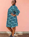 Model wearing dress with teal shaded loop print.