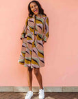 Model wearing neutral color geometric print dress.