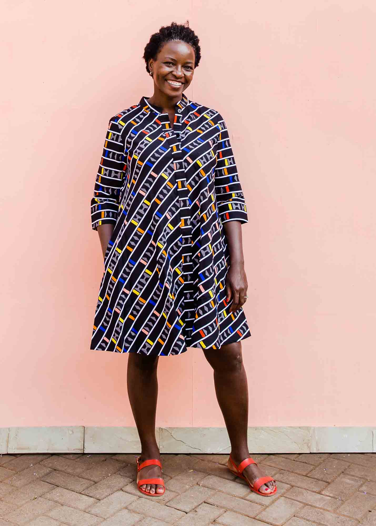 model wearing a multicolored and black striped dress