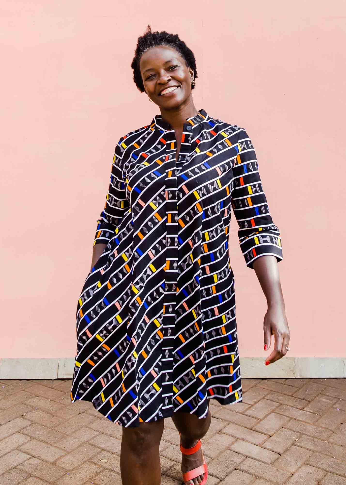model wearing a multicolored and black striped dress