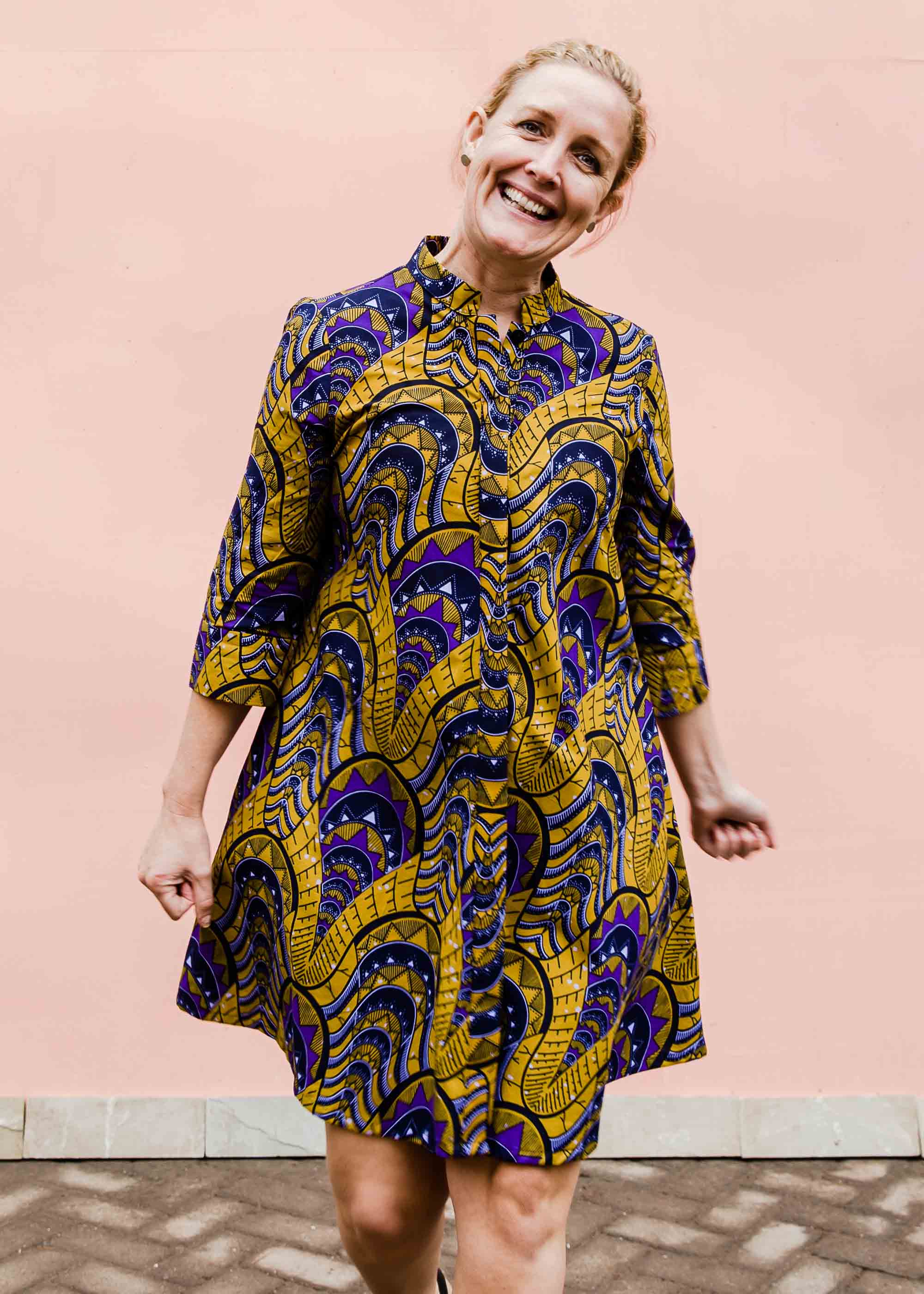 model wearing a gold and purple empire state building design dress