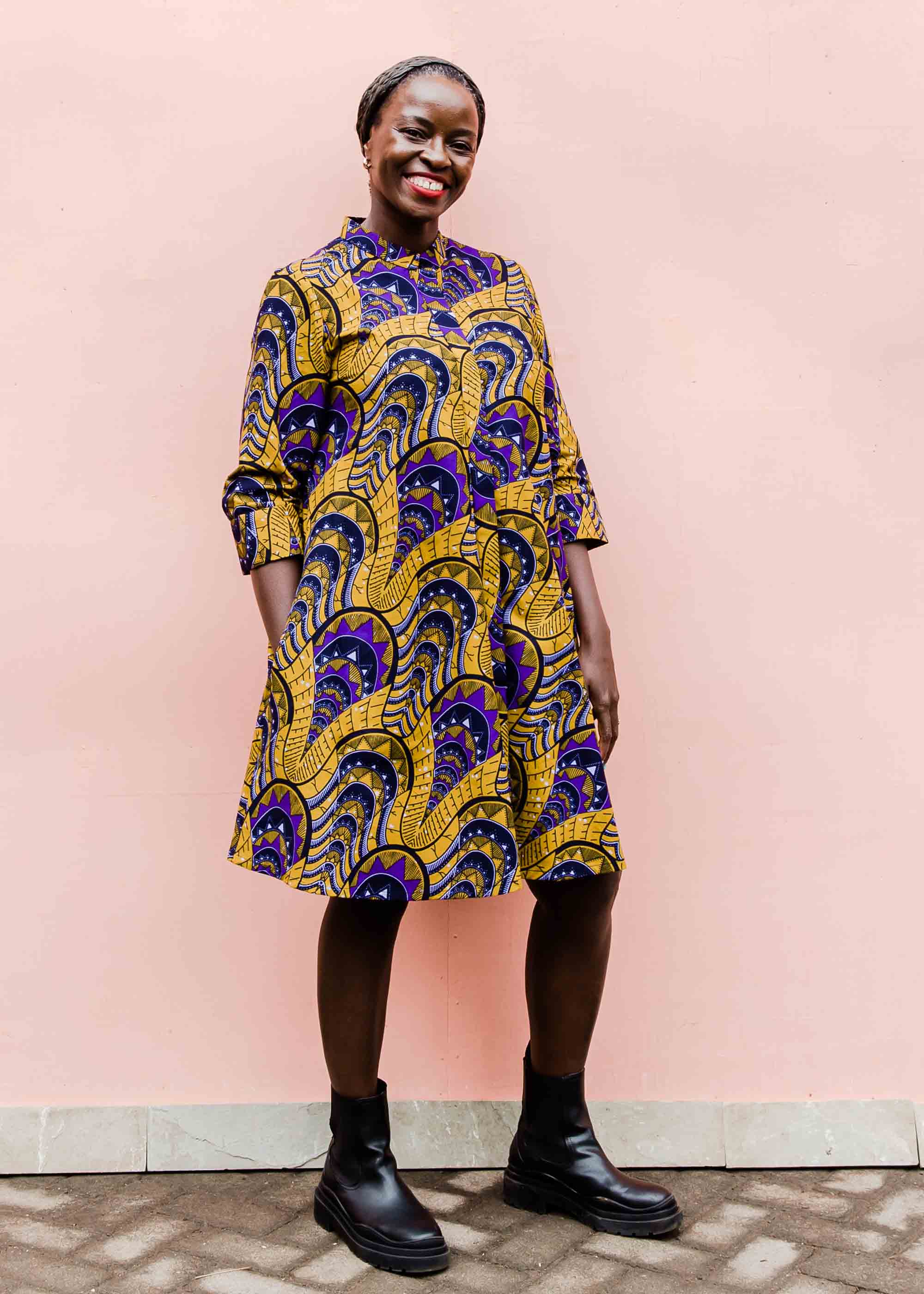 model wearing a gold and purple empire state building design dress
