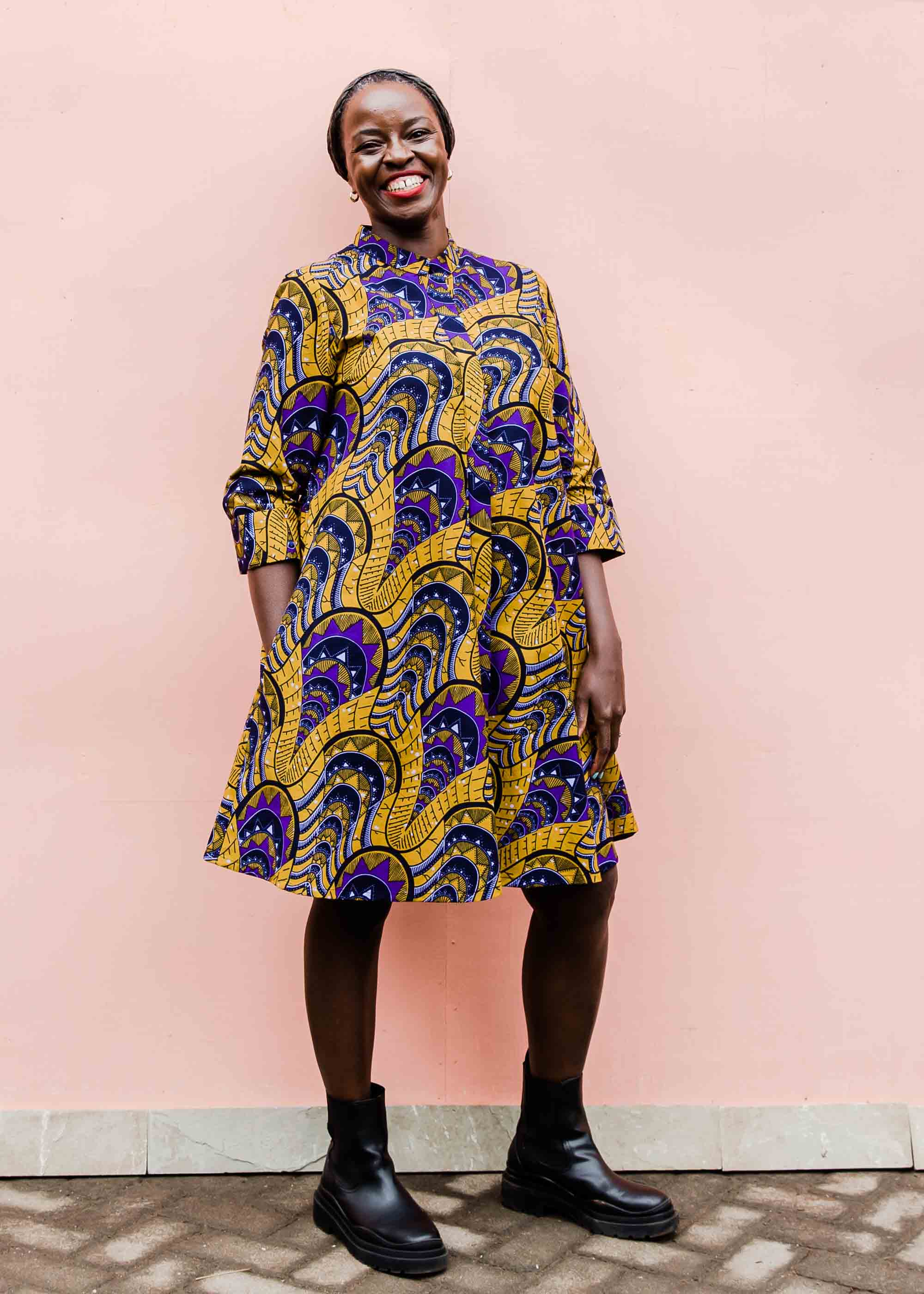 model wearing a gold and purple empire state building design dress