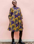 model wearing a gold and purple empire state building design dress