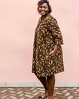 model wearing a brown, black and white seed design dress