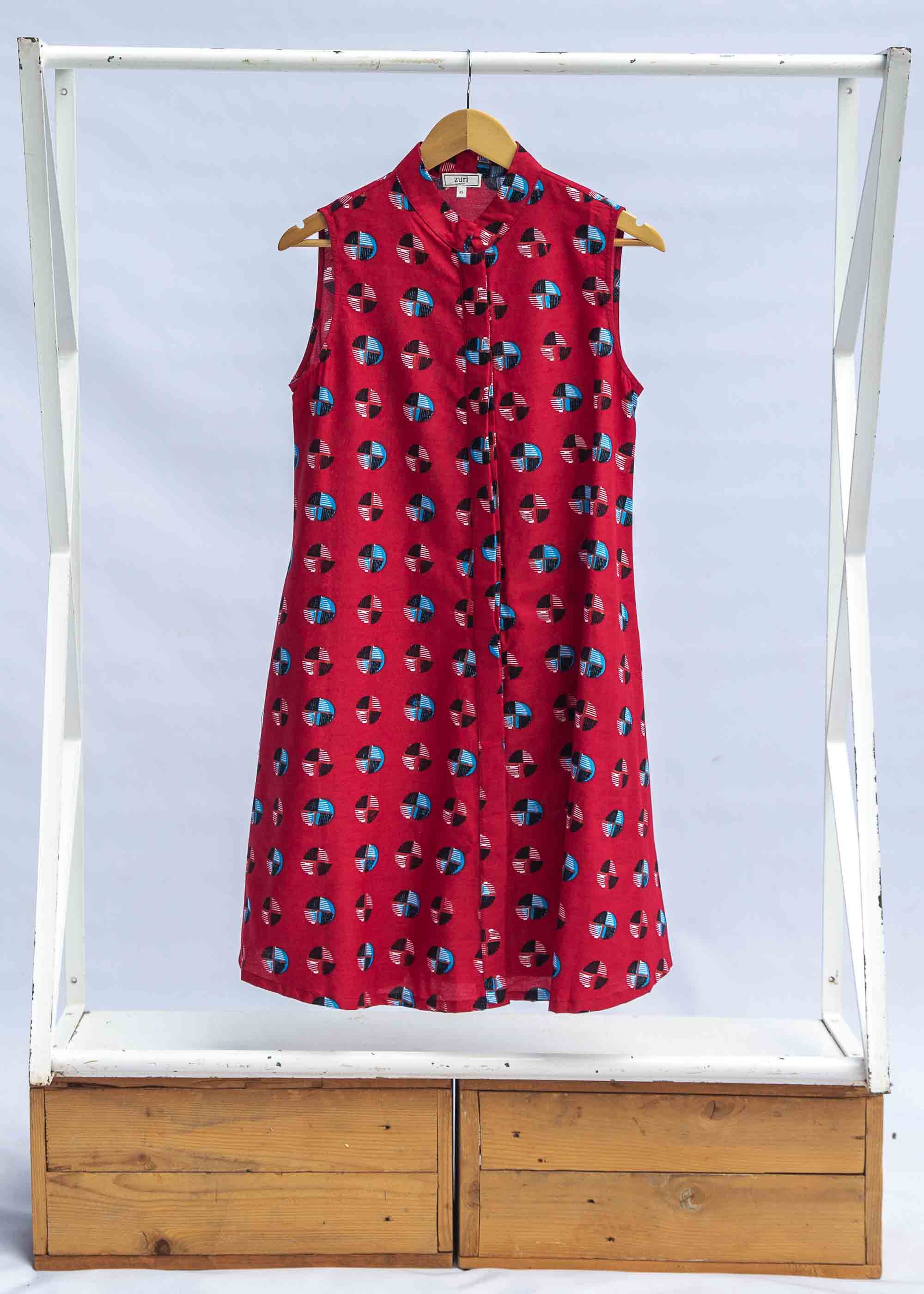 display of a sleeveless dress with a red, blue, white and black design