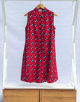 display of a sleeveless dress with a red, blue, white and black design