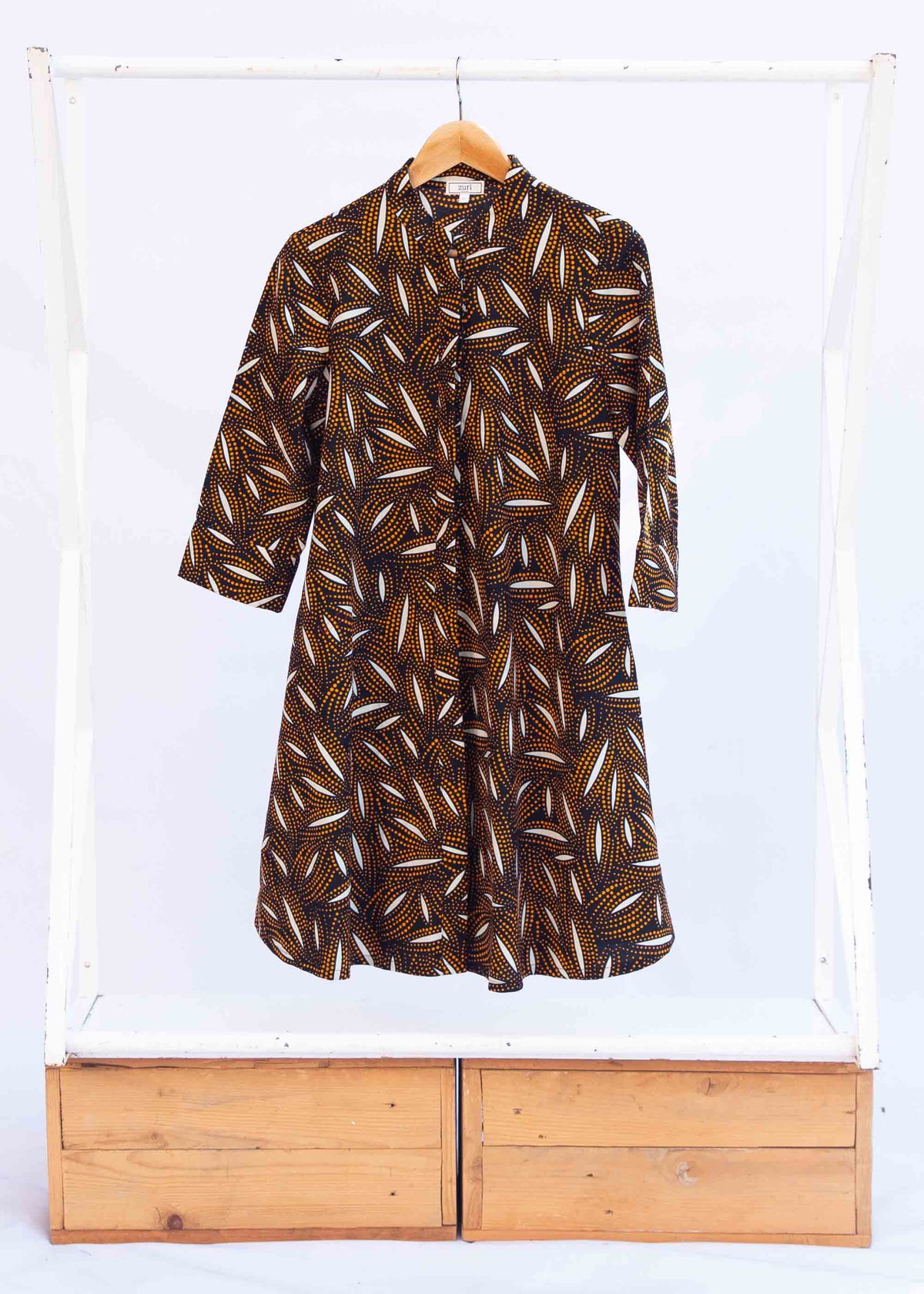 Display of a brown, black and white seed design dress
