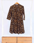 Display of a brown, black and white seed design dress
