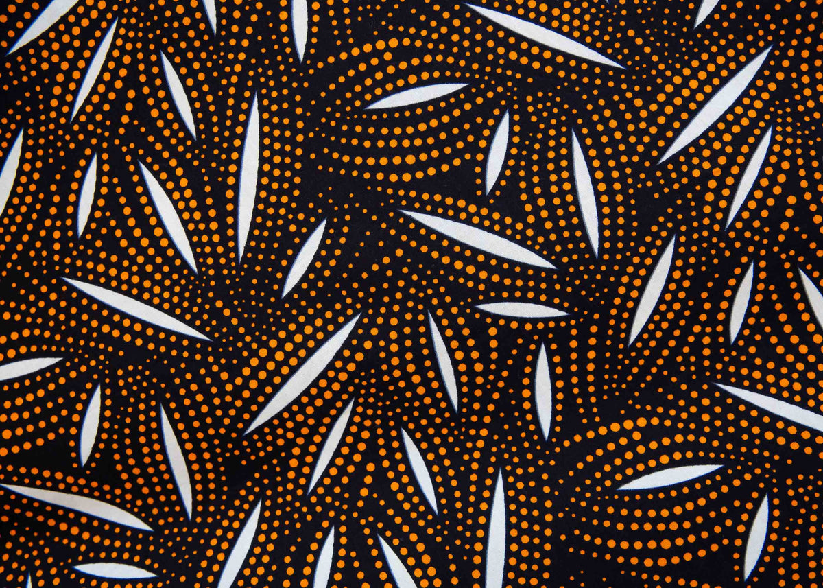 Display of a brown, black and white seed design dress