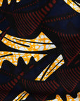 Display of long sleeve blouse with brown and yellow abstract print.