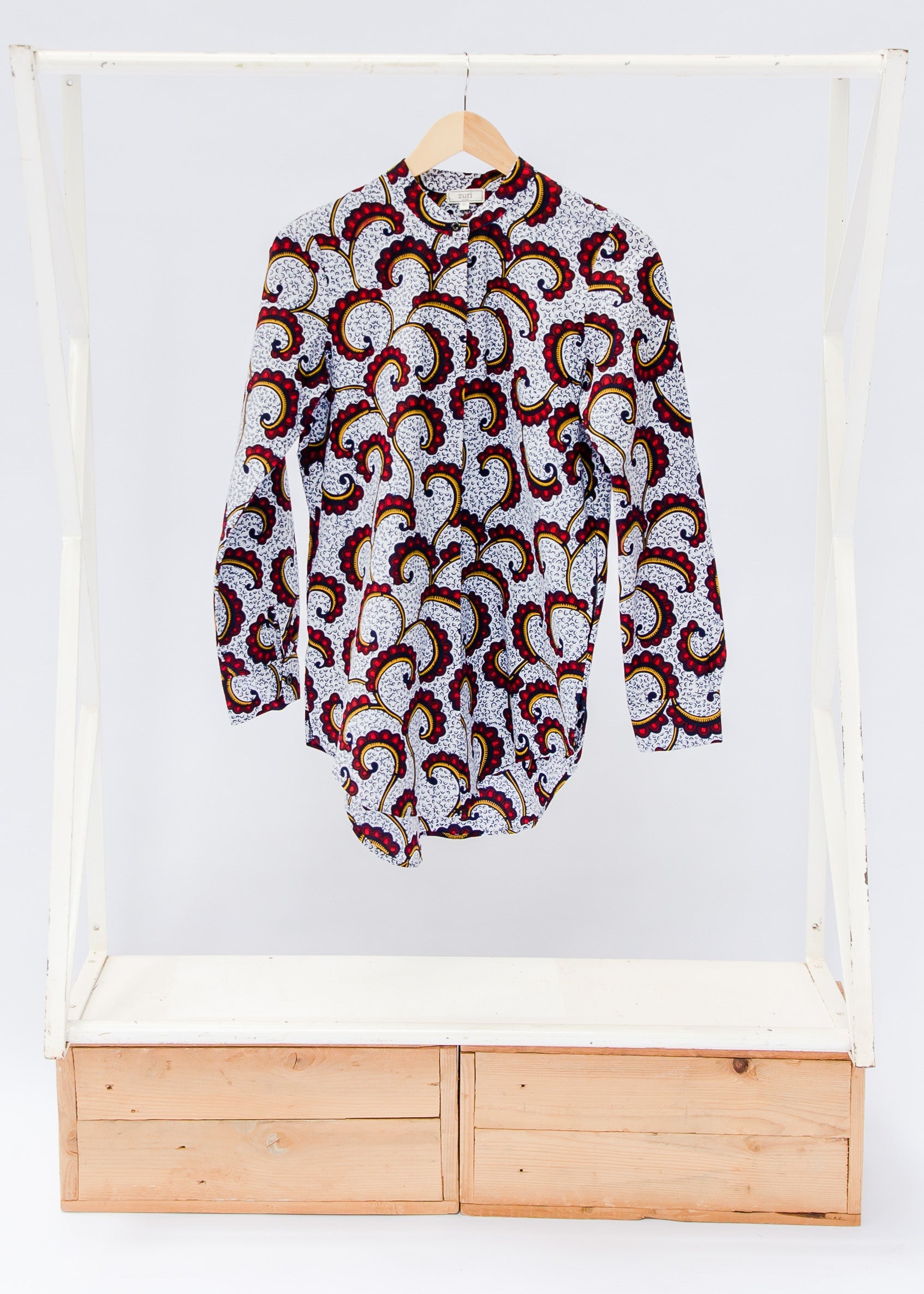 White shirt with red vines and tendrils