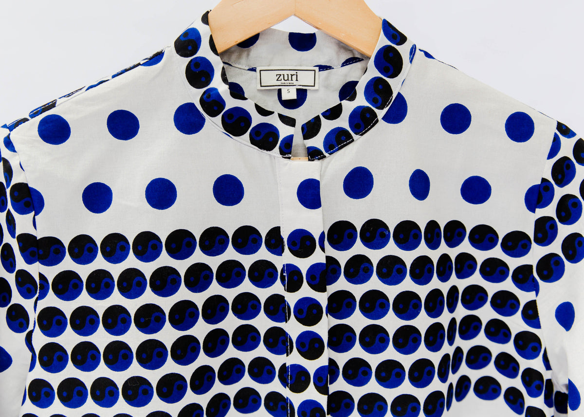 White shirt with blue and black yin yang dots
