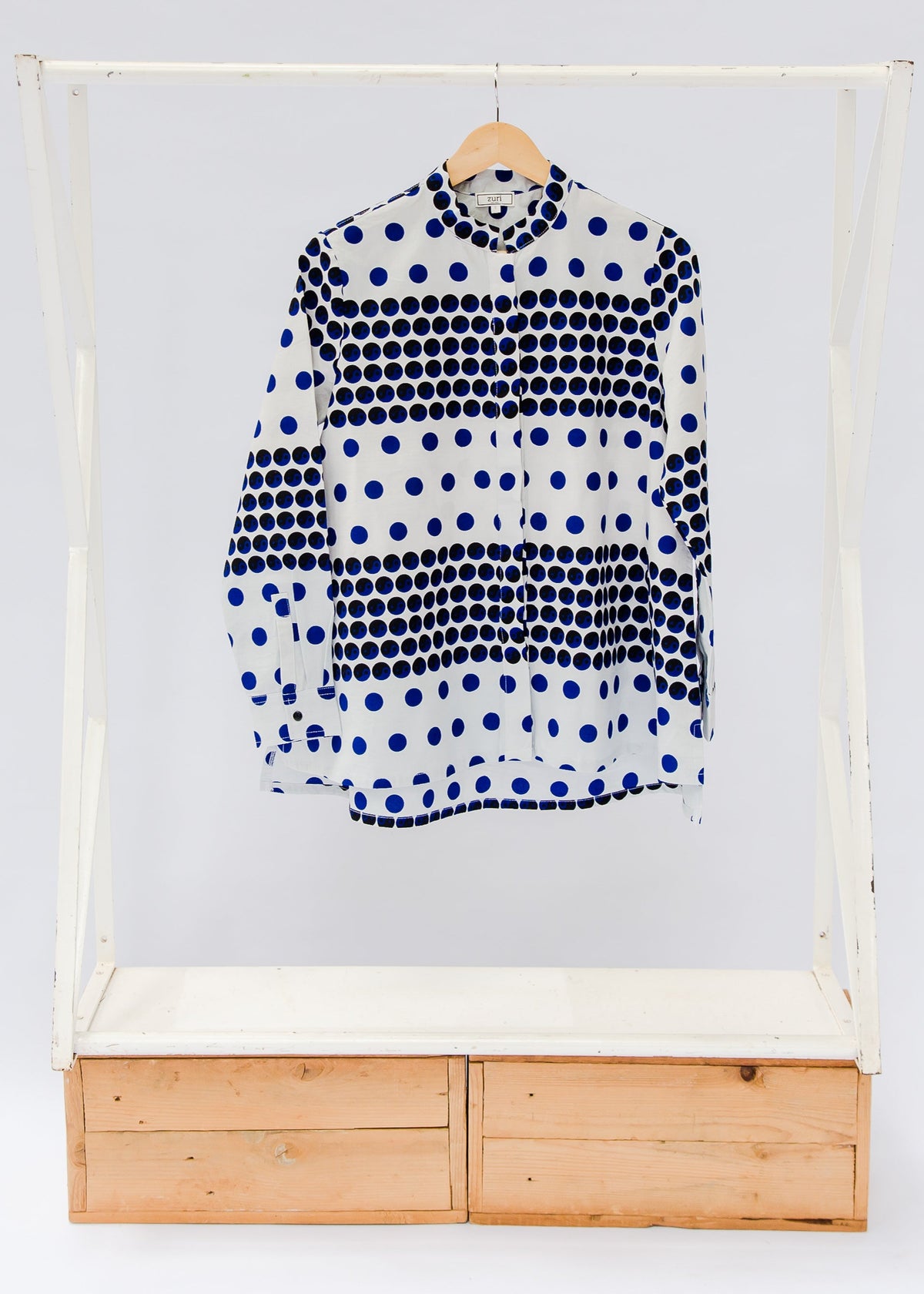 White shirt with blue and black yin yang dots