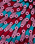 Display of pink, red, blue and black tube print long sleeve blouse.