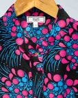 Display of black sleeveless dress with blue and pink poppy print.