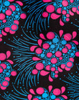 Display of black sleeveless dress with blue and pink poppy print.