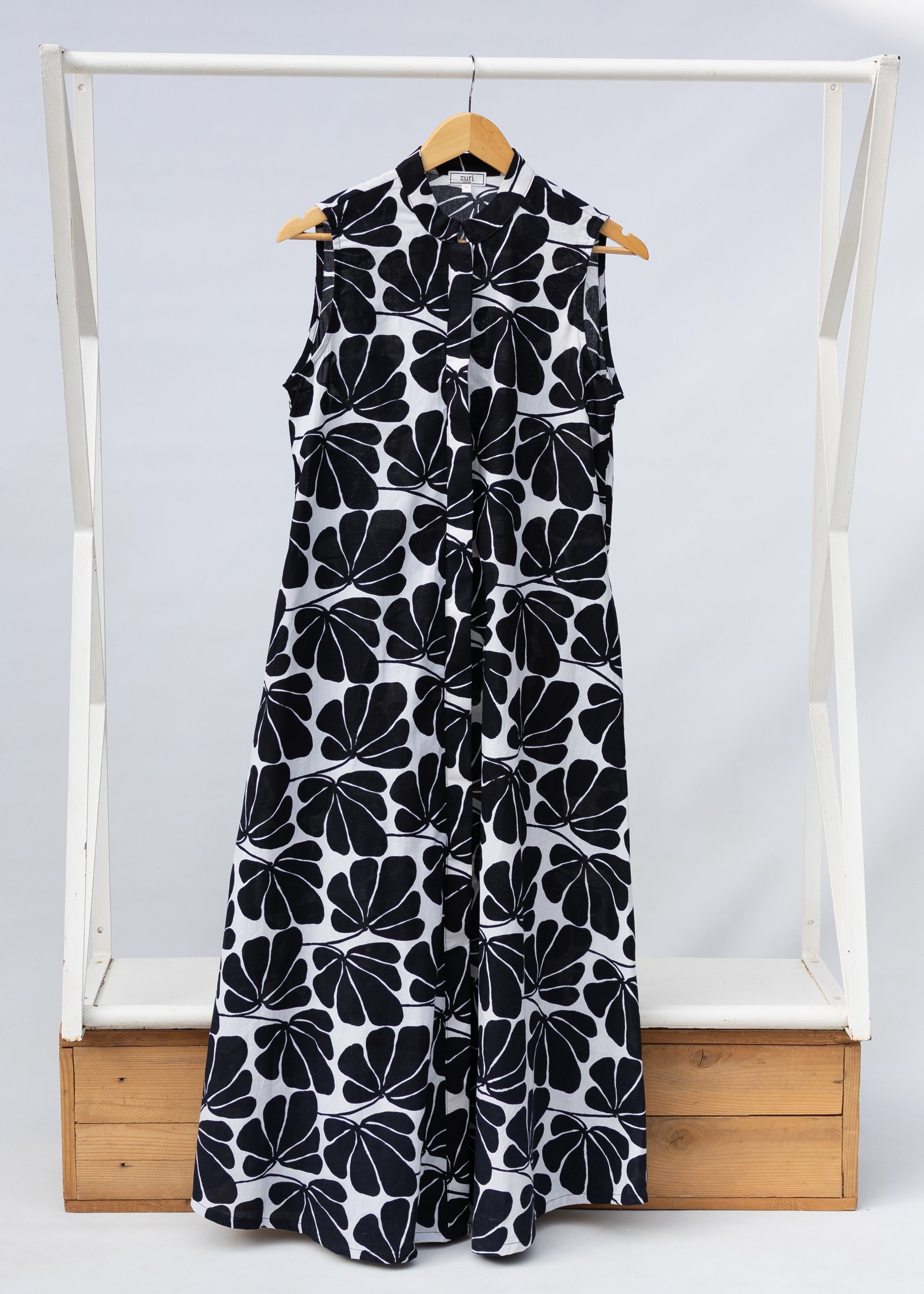 Display of black and white floral print, sleeveless dress.