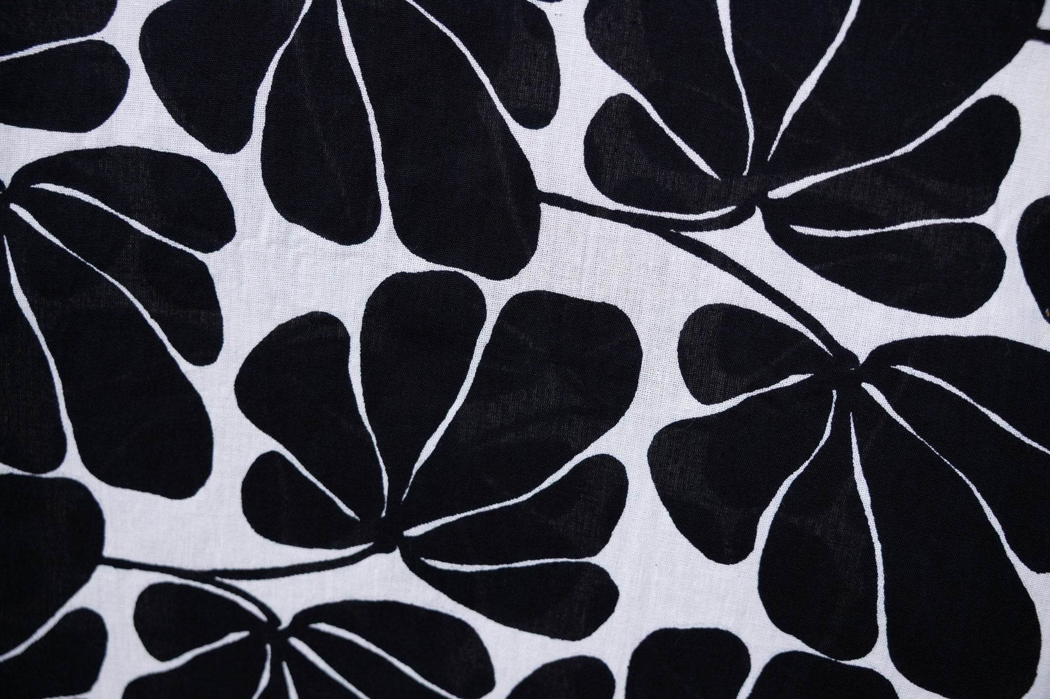 Close up display of black and white floral print dress, fabric.
