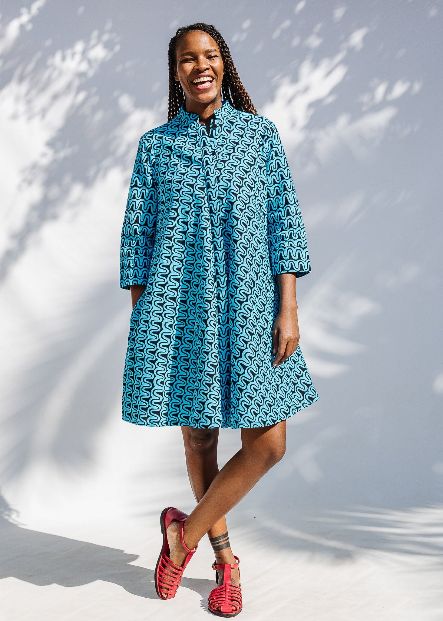 Model wearing blue and black squiggle print dress.