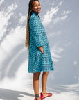 Model wearing blue and black squiggle print dress.