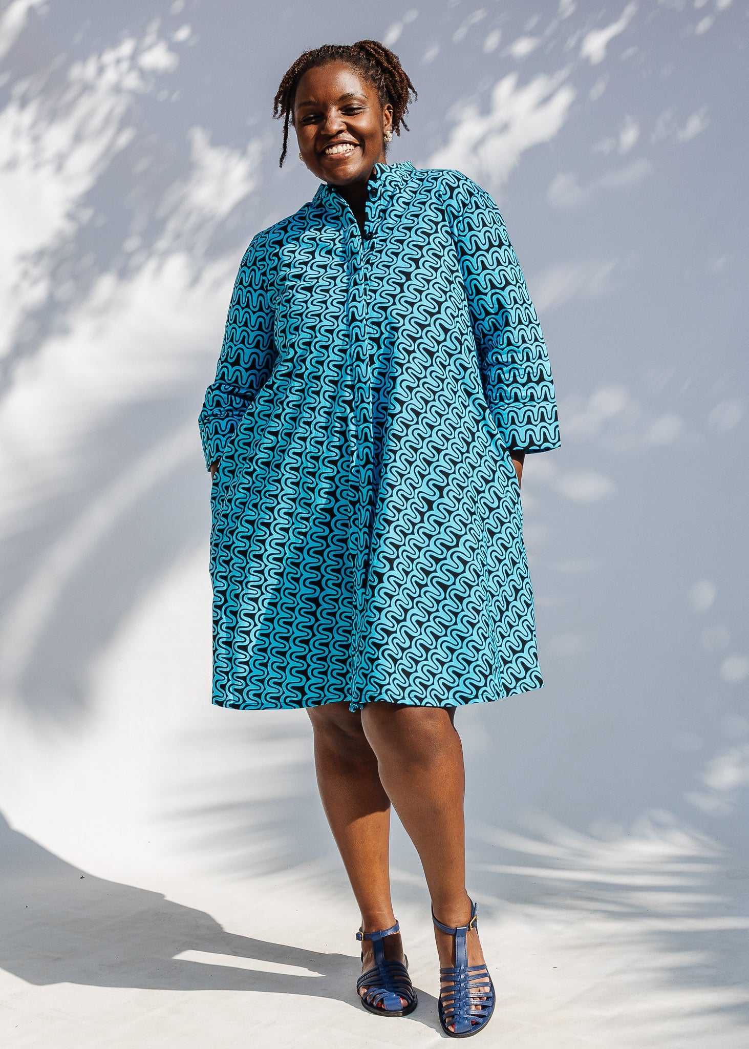 Model wearing blue and black squiggle print dress.